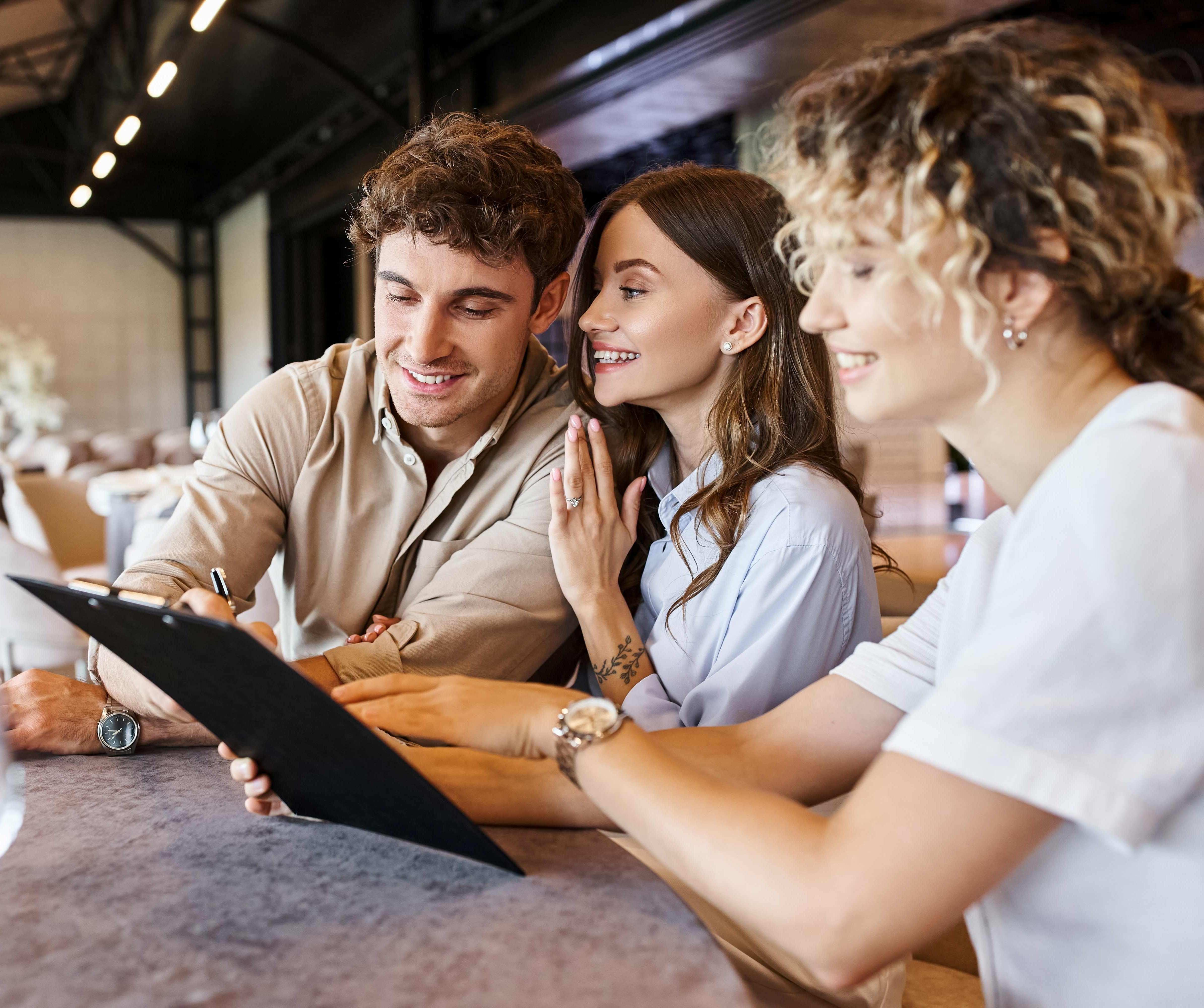 Couple signing a wedding venue contract